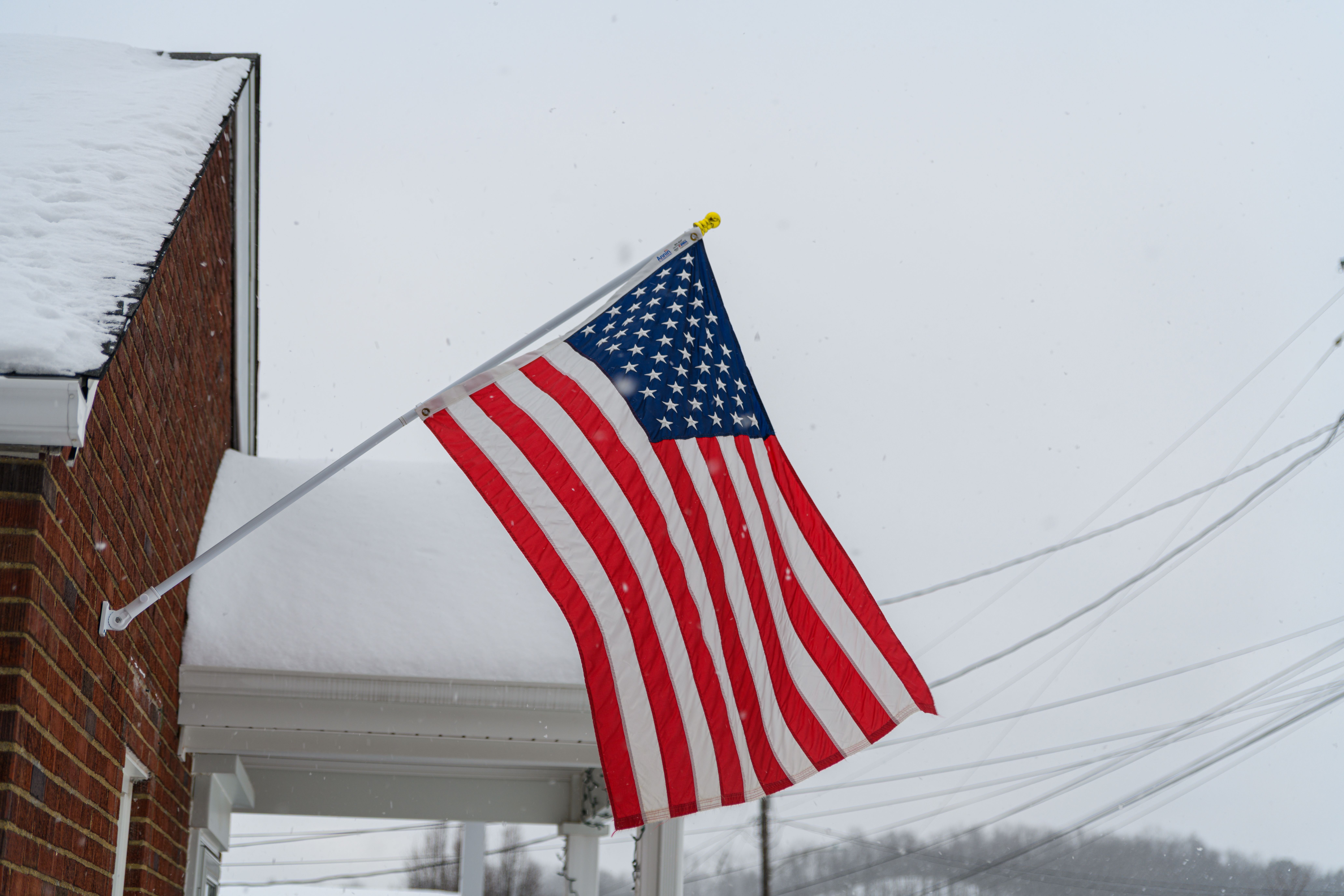 American Flag on a wintry Pennsylvania day with snowy roofs
